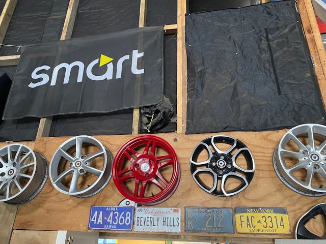 Smart Car wheels and other parts displayed on a table
